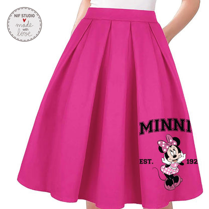A bright pink pleated skirt with a Minnie Mouse design and the text &quot;MINN&quot; and &quot;EST. 192&quot; printed on it.