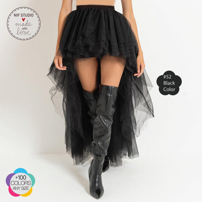 a woman wearing a black skirt and boots