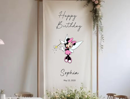 A banner with a Minnie Mouse character and the text &quot;Happy Birthday Sophia&quot; is displayed in a room with floral decorations.
