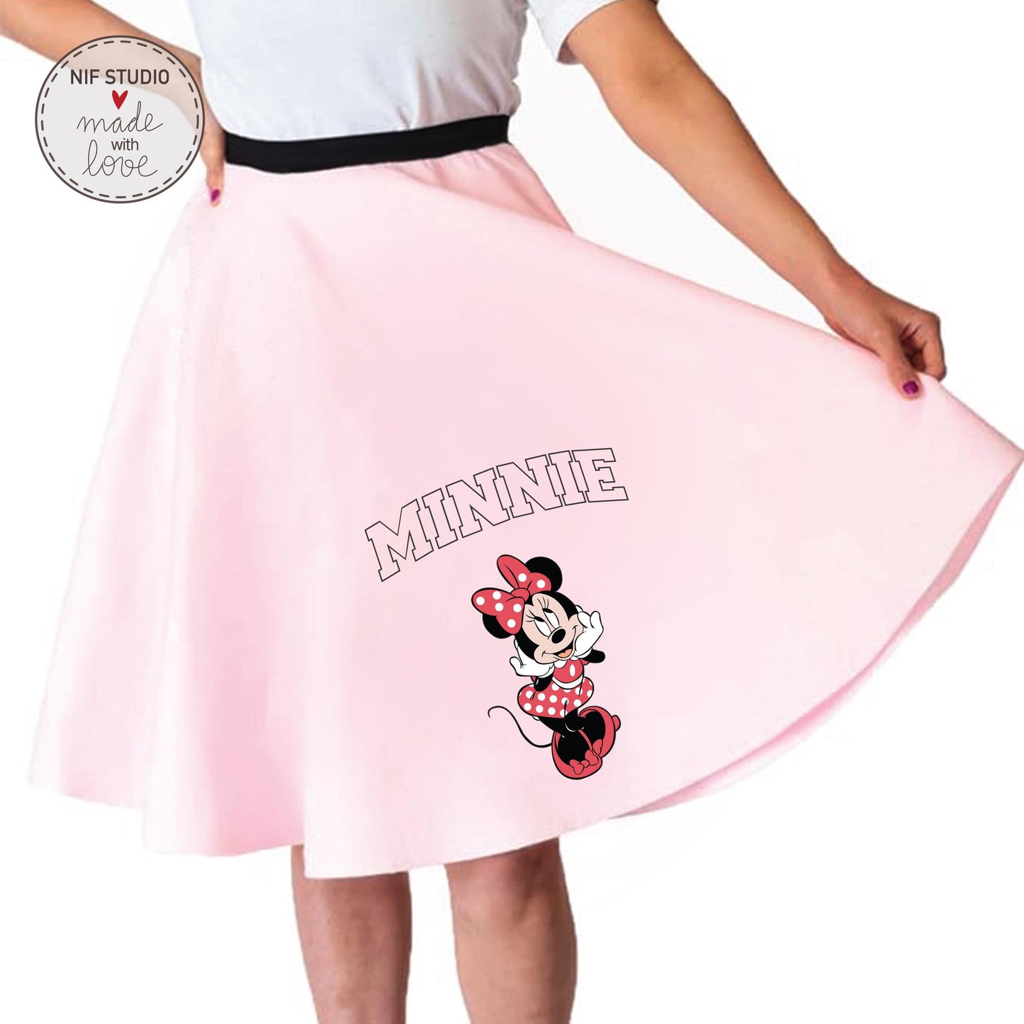 A woman wearing a pink skirt with a Minnie Mouse design printed on it.