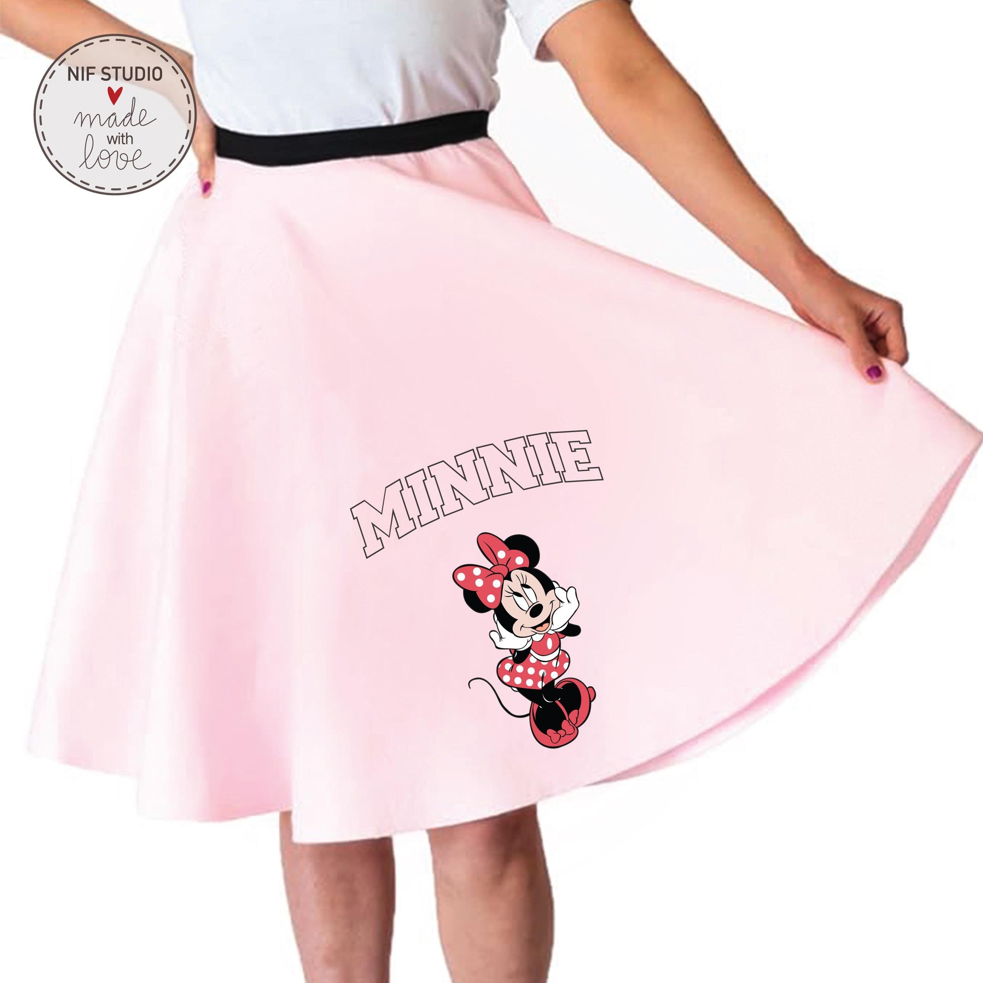 A woman wearing a pink skirt with a Minnie Mouse design printed on it.