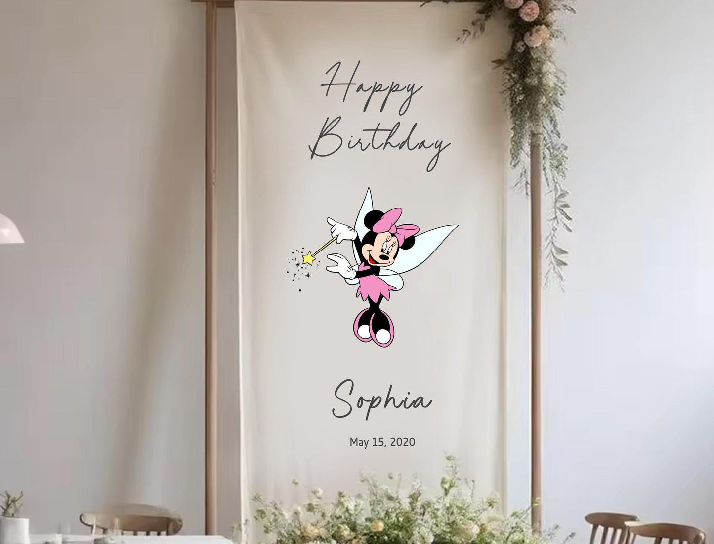 A banner with a Minnie Mouse character and the text &quot;Happy Birthday Sophia&quot; is displayed in a room with floral decorations.