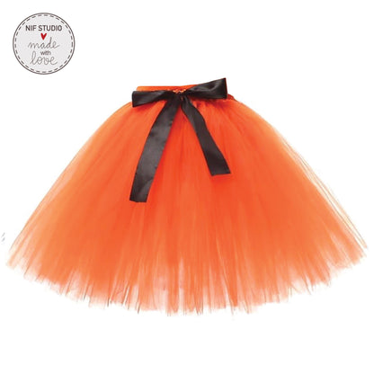 A bright orange tulle skirt with a black bow tied at the waist.