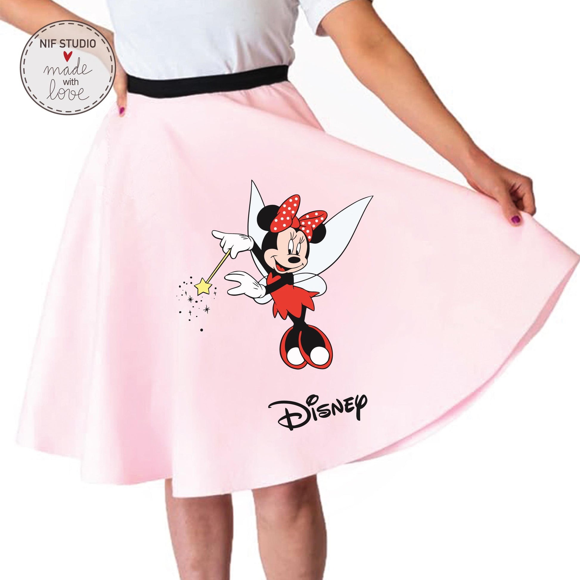 A woman is wearing a pink skirt with a Minnie Mouse design and the Disney logo.