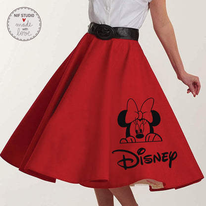 A woman wearing a red skirt with a black Minnie Mouse design and the Disney logo printed on it.