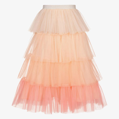 A three-tiered tulle skirt in a light peach color.