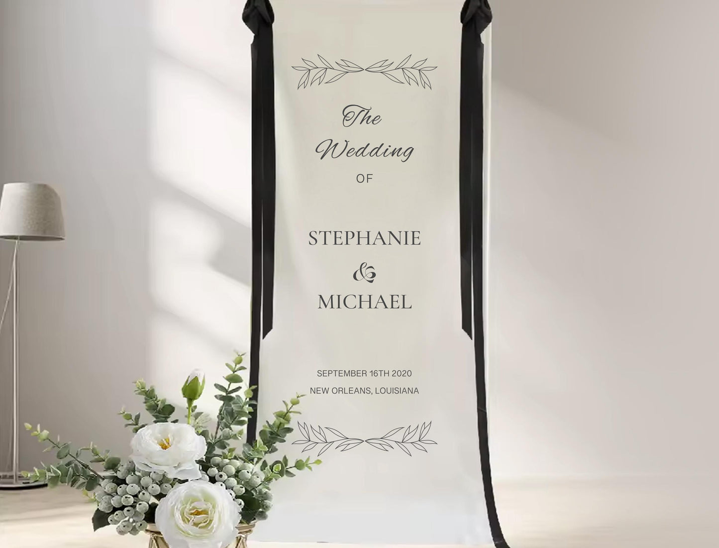 a wedding invitation banner for Stephanie and Michael, with a floral arrangement in the foreground.