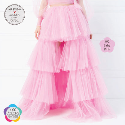 a woman in a pink dress with a long skirt