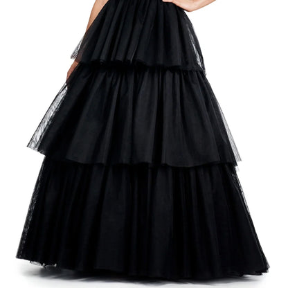 A woman wearing a long, black, ruffled skirt with multiple layers.