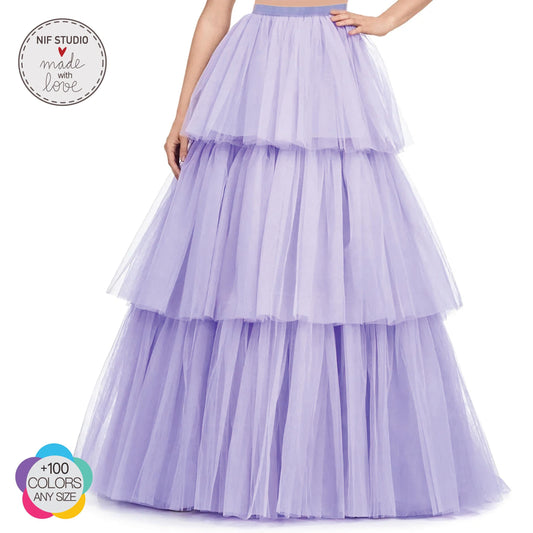 A woman wearing a long, layered, tiered purple dress with a full skirt.